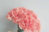 a fab coral carnation wedding bouquet with a ribbon is a lovely idea for a bold spring or summer bride