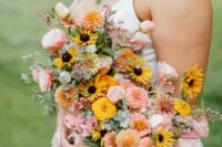 a fantastic pink and yellow dahlias and rose wedding bouquet with just a bit of greenery for a summer wedding