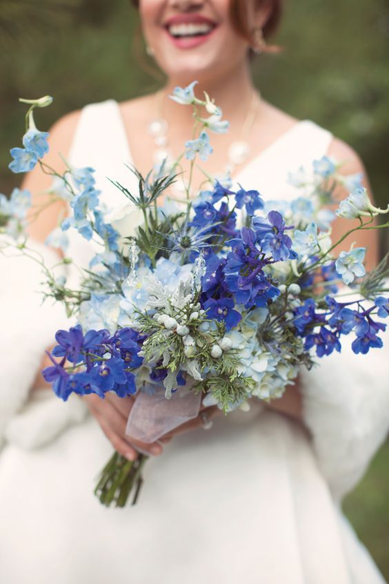 a gorgeous blue wedding bouquet with pastel blue and bold blue to purple blooms plus greenery is a fantastic idea