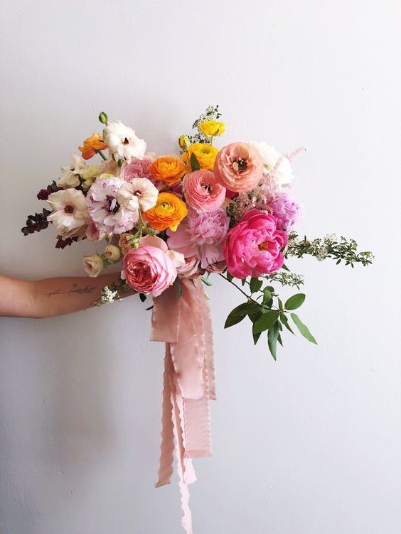a gorgeous candy-colored wedding bouquet with peonies, anemones, carnations and some greenery