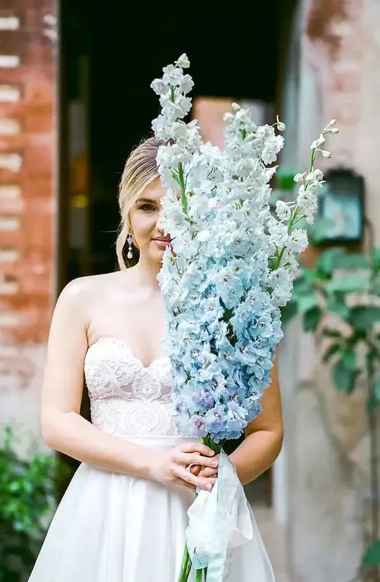 a gorgeous long-stem wedding bouquet of serenity blue delphinium is a fantastic idea for a delicate and refined bridal look