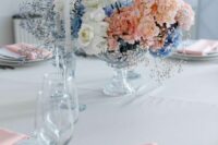 a gorgeous lush wedding centerpiece of white roses, pink hydrangeas, blue and purple baby’s breath is a chic and cool idea