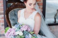 a gorgeous pastel-colored wedding bouquet of pink and blue hydrangeas, white blooms and greenery and pink ribbons is amazing for spring