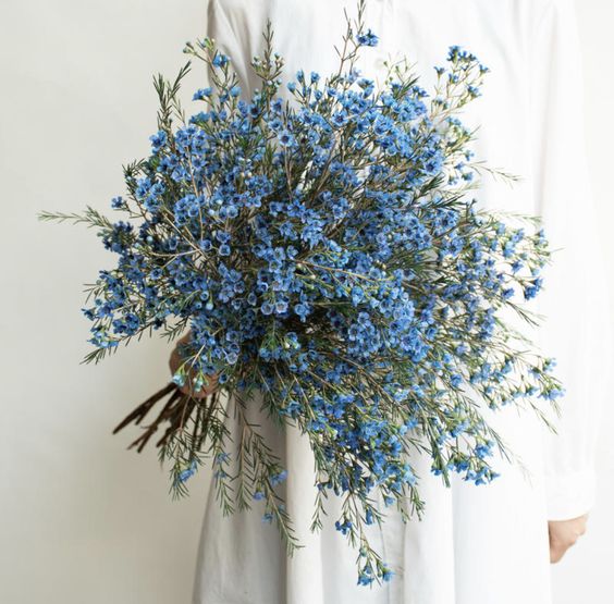 a jaw-dropping textural blue wedding bouquet with much greenery is a fantastic idea for a modern wedding and it can be used for a boho one, too