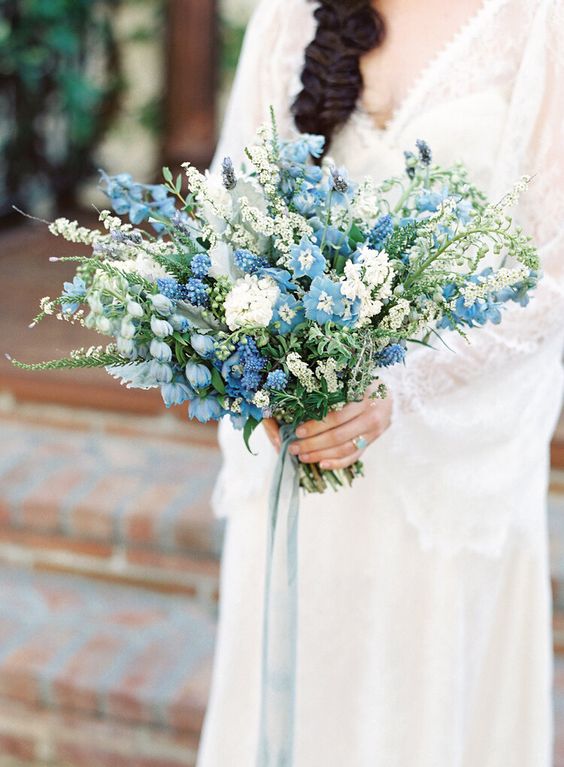 a jaw-dropping wedding bouquet of several types of white blooms and white ones plus some greenery if you wanna make a statement with blues