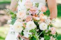 a lovely summer wedding bouquet of white dahlias, peachy and coral ranunculus, greenery and fillers is chic