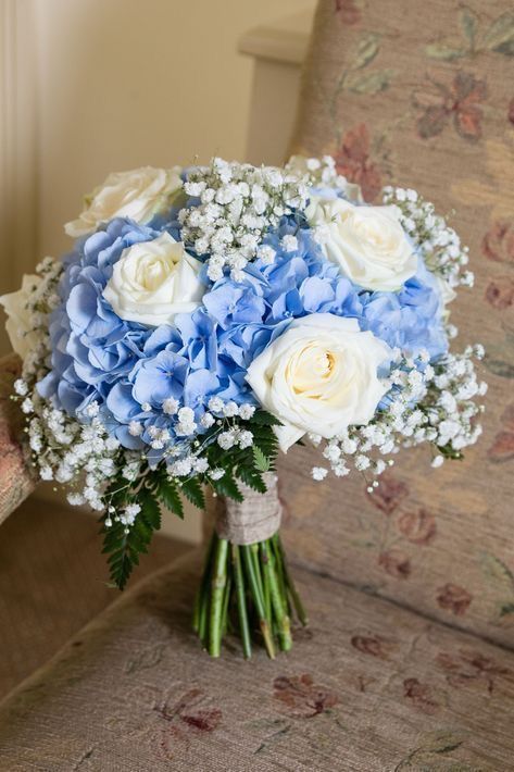 a lovely wedding bouquet of blue hydrangeas, baby's breath and white roses is a catchy idea for spring or summer