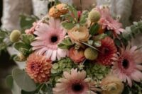 a lovely wedding bouquet of green hydrangeas, pink gerberas, orange dahlias, billy balls and greenery for a summer wedding