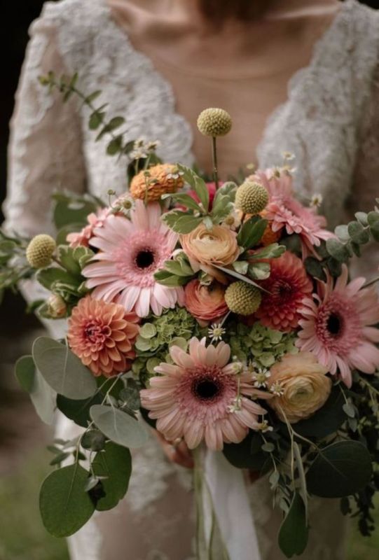 a lovely wedding bouquet of green hydrangeas, pink gerberas, orange dahlias, billy balls and greenery for a summer wedding