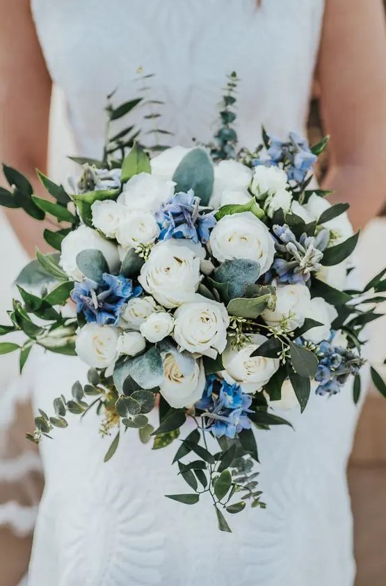 a lovely wedding bouquet of white and blue flowers, greenery is a very delicate and chic idea for a spring or summer wedding