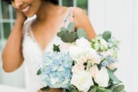 a lovely wedding bouquet with blue hydrangeas, white and blush roses, some waxflowers and greenery for summer or spring