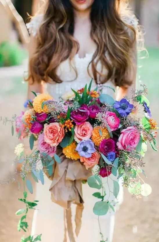 a lush colorful bouquet in pink, yellow, purple and fuchsia plus eucalyptus is a gorgeous option if you want a colorful wedding bouquet