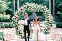 a lush round wedding arch decorated with greenery and blush blooms is a beautiful and elegant idea for a chic garden wedding
