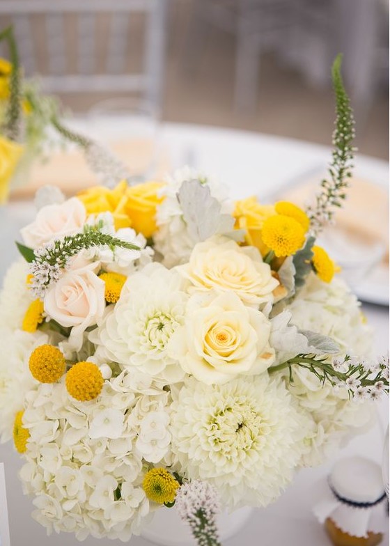 a lush summer wedding centerpiece of white and blush blooms, billy balls and astilbe is a pretty idea to rock