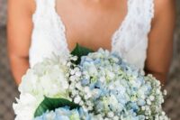 a neutral wedding bouquet of blue and white hydrangeas and baby’s breath is a classic and affordable idea