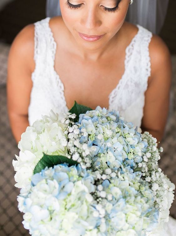 a neutral wedding bouquet of blue and white hydrangeas and baby's breath is a classic and affordable idea