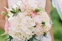 a neutral wedding bouquet of white hydrangeas, blush roses, greenery and astilbe is a lovely idea for spring or summer