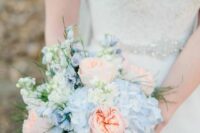 a pastel wedding bouquet of white and blue hydrangeas, peachy peony roses and greenery is a stylish idea for spring and summer