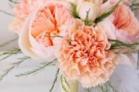 a peachy wedding bouquet of carnations and peony roses plus some greenery is a very cool and bright idea for spring or summer