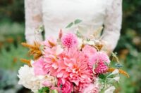 a pink wedding bouquet of two types of dahlias and some roses, some greenery and berries is a cool idea for summer