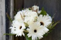 a pretty and stylish wedding bouquet of white gerberas and leaves is a timeless idea for a wedding, and you can DIY such an arrangement yourself