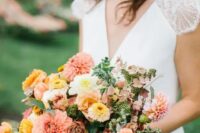 a pretty summer to fall wedding bouquet of yellow, pink and white dahlias, some roses and greenery is wow