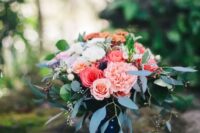 a pretty wedding bouquet of coral and pink roses and pink carnations, greenery and a wrap is a stylish and cool idea for summer
