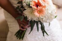 a pretty wedding bouquet of white dahlias and hydrangeas, orange gerberas, greenery is a cool idea for a rustic wedding