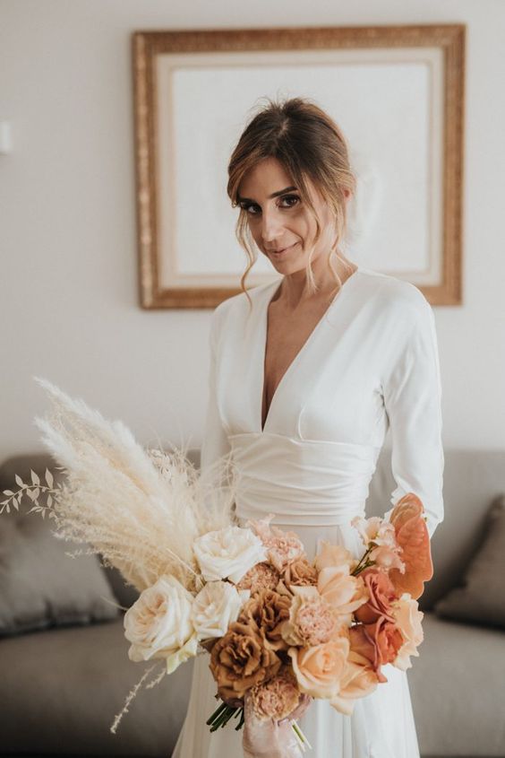 a refined modern wedding bouquet with an ombre effect, white, coffee-colored, peachy and rust roses, blush carnations, pampas grass