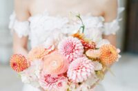 a refined wedding bouquet of pink and orange dahlias, neutral blooms and peachy ranunculus plus ribbons