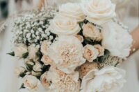 a refined wedding bouquet of white roses and carnations, greenery and baby’s breath is a very chic and lovely idea for summer