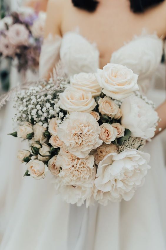 a refined wedding bouquet of white roses and carnations, greenery and baby's breath is a very chic and lovely idea for summer