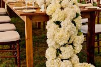 a rich ivory hydrangea floral table runner makes a wow effect and is a great alternative to a usual wedding centerpiece