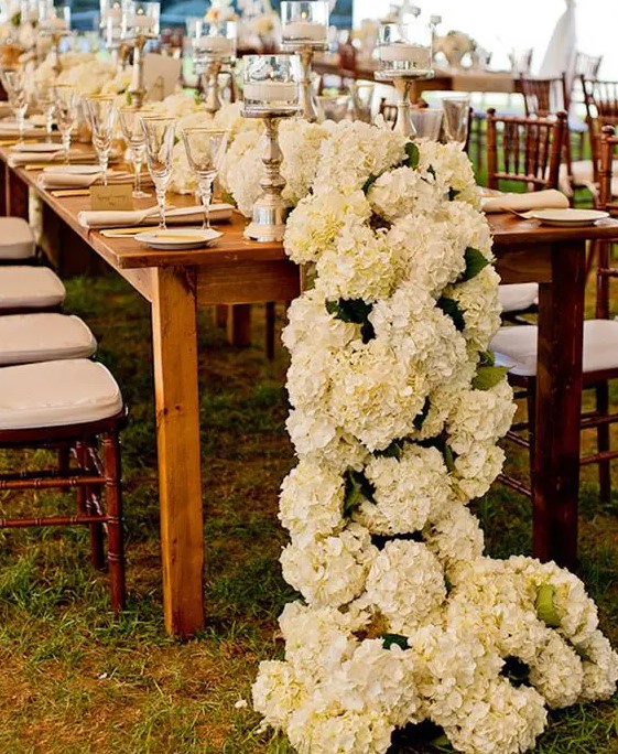 a rich ivory hydrangea floral table runner makes a wow effect and is a great alternative to a usual wedding centerpiece