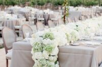 a simple and cool lush wedding table runner of green and white hydrangeas is a beautiful idea for spring and summer