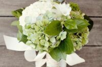 a simple and cute wedding bouquet of green and white hydrangeas, some leaves and ribbons is a cool idea for spring and summer