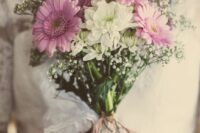 a simple and pretty wedding bouquet of pink gerberas, white mums, baby’s breath and a delicate lace and twine wrap