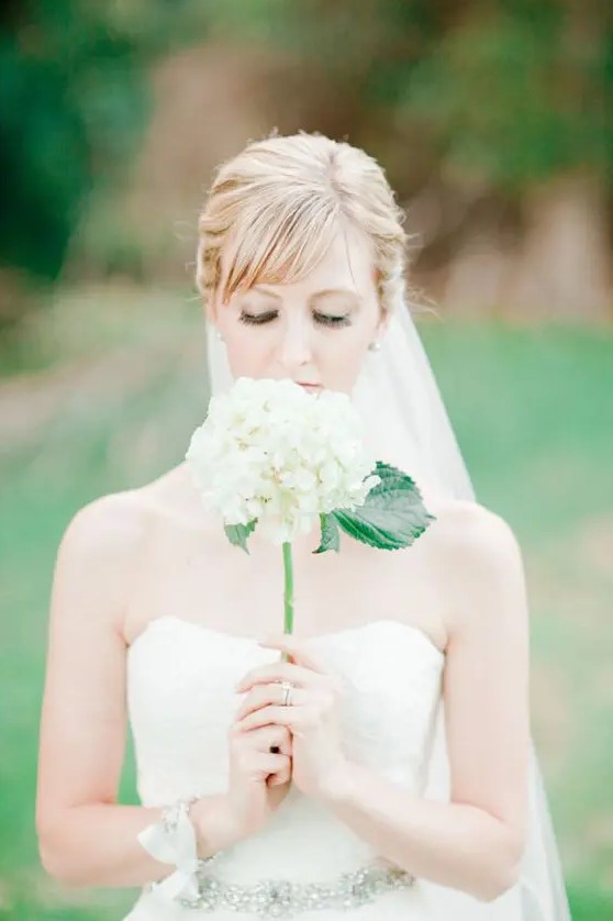 a single stem white hydrangea wedding bouquet is a cute idea with a rustic feel