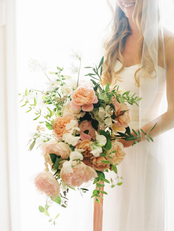a subtle wedding bouquet of blush carnations, white blooms, some greenery is a very chic idea for spring or summer