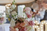a subtle wedding centerpiece of white, pink and peachy carnations is a lovely idea for a wedding, it looks cute