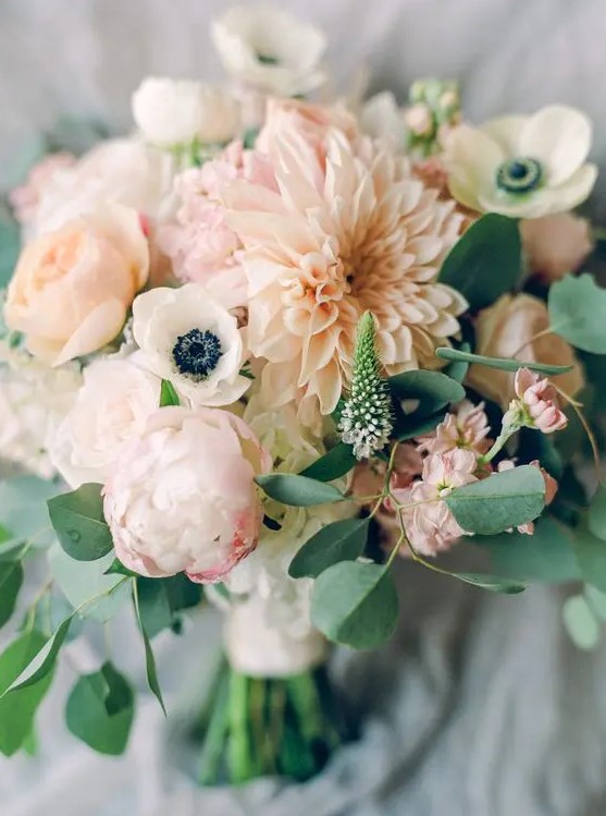 a super delicate blush wedding bouquet with white anemones, blush dahlias and peonies, astilbe and greenery