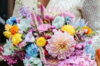 a vibrant wedding bouquet of hot pink, blush, yellow, blue and mint blooms, greenery and bright ribbon is amazing for a super bold wedding
