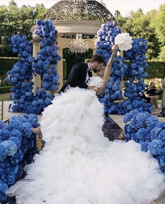 a wedding rotonda fully done with bold blue and navy hydrangeas and the aisle lined up with them, too, looks jaw-dropping
