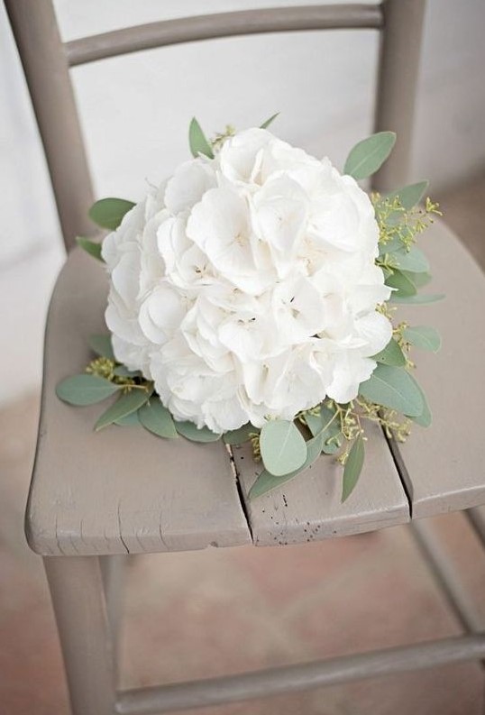 a white hydrangeas wedding bouquet with eucalyptus is a chic rustic idea for a bride