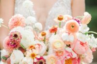 an amazing pink wedding bouquet of pink, coral dahlias, neutral roses and dahlias, peonies and peony roses