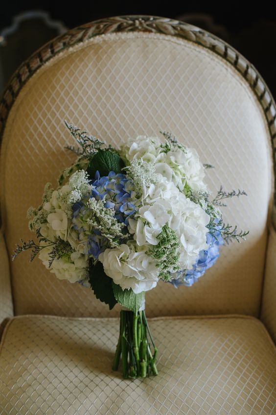 an elegant wedding bouquet of white and blue hydrangeas, greenery and some fillers is a stylish idea for spring and summer