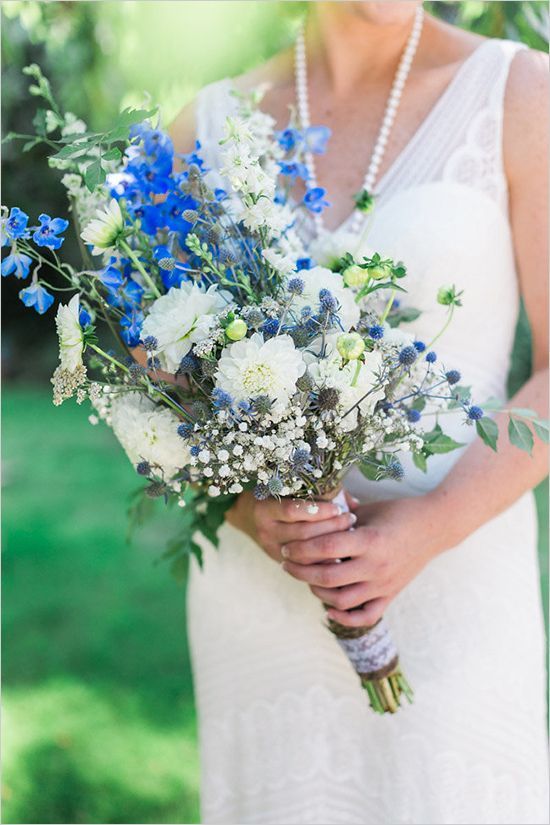 an eye-catching wedding bouquet of white and bold blue blooms, thistles, baby's breah and some greenery is very cool