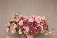 an eye-catchy wedding centerpiece of pink and burgundy carnations is a lovely idea for a wedding