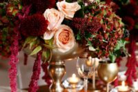 02 a decadent wedding centerpiece of blush roses, burgundy mumes, berries, greenery and amaranthus is a very refined solution
