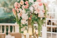 03 a delicate pastel wedding centerpiece of white hydrangeas, blush roses, greenery and cascading green amaranthus